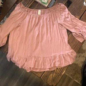 Pink flowy blouse with ruffles accents
